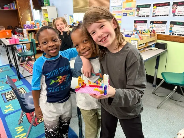 Children sharing a classroom building activity at Brookline Sprouts
