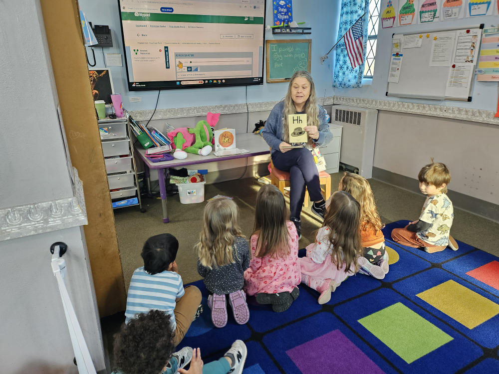 Teacher helping a child with early learning work