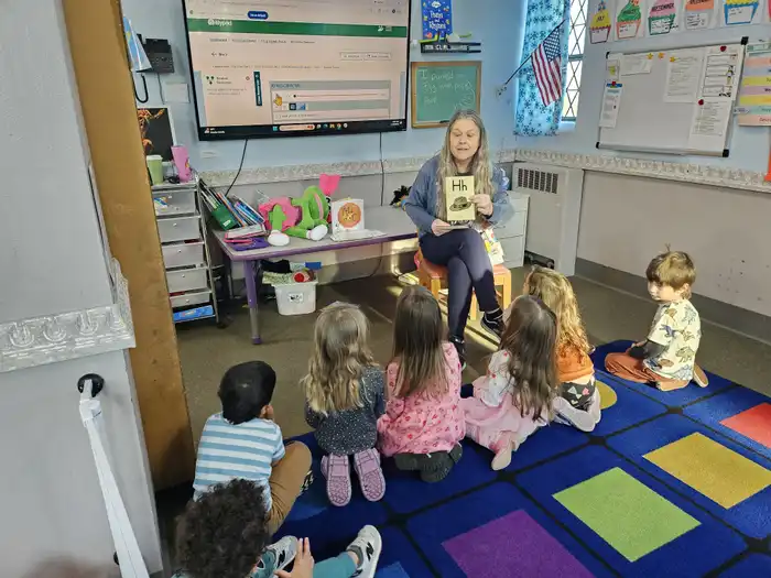 Teacher helping a child with early learning work