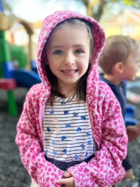 Preschool child smiling outside