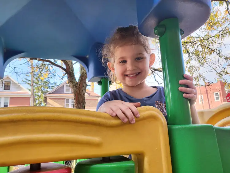Preschool child playing outside