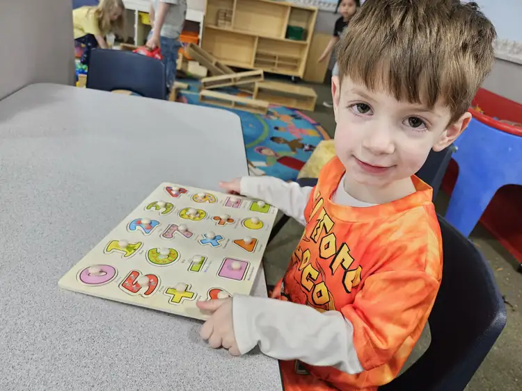 Preschool child proudly finishing an activity