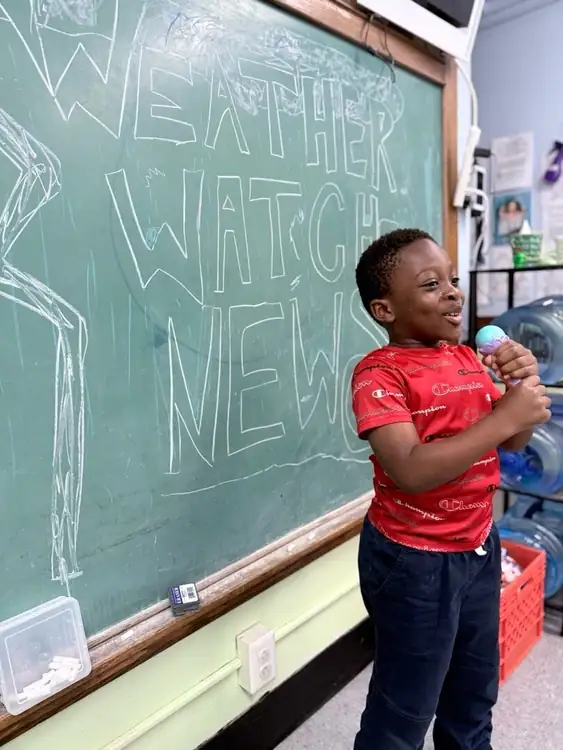 A Brookline Sprouts student presenting the classroom weather update